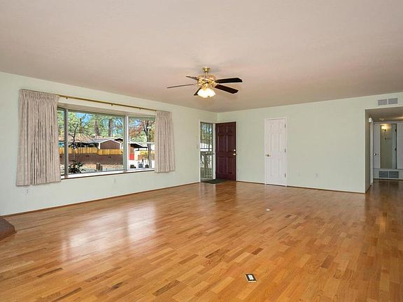 view of living room, picture front window, front entrance and hallway to bedrooms
