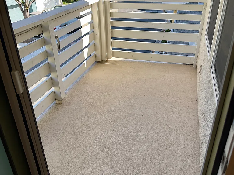 Exterior balcony off of the dining area with mangetic sliding screen door.