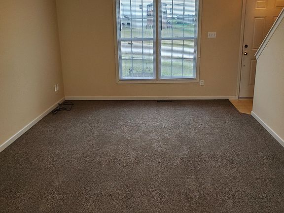 Freshly painted and new carpet in the main level living room.