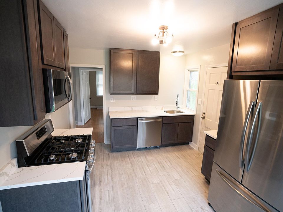 The kitchen features brand new stainless appliances with a gas range, dishwasher, and quartz countertops.