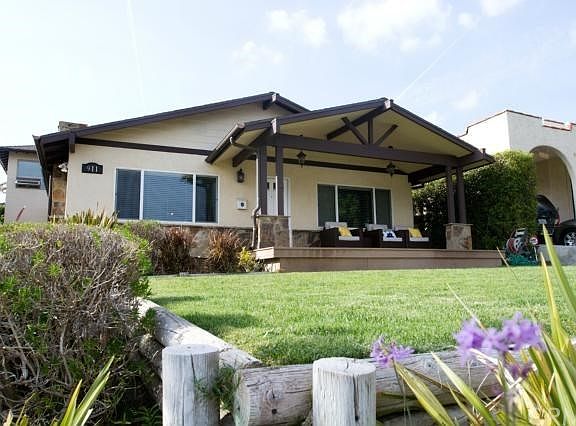 Flat useable front yard surrounded by landscaping