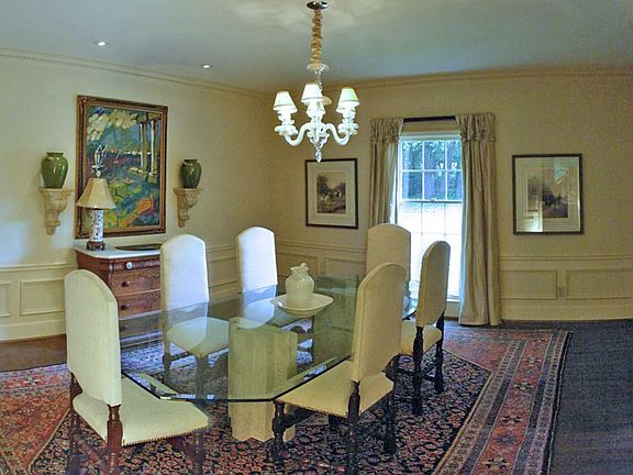 Dining Room features floor to ceiling window and unique chandelier... seats 12