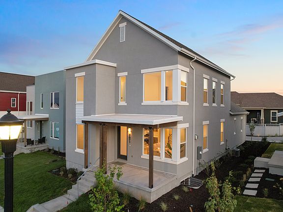 A modern two-story gray house from the Contempo Collection with large windows, a covered front porch