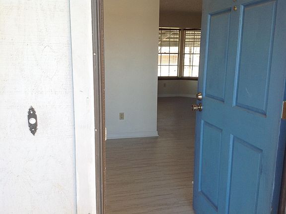 Entryway and view of living room. Hall closet behind door.