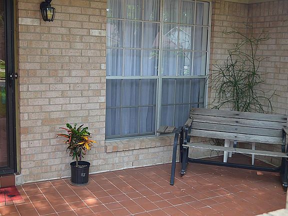 You'll love the large and inviting porch entry with a brick courtyard style entry. Solid front door plus glass storm door.