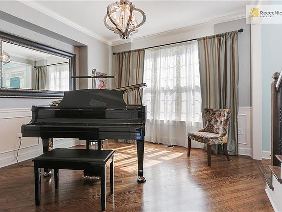 Note the beautiful hardwood flooring, installed at an angle, as well as the wainscoting and large window for plenty of natural light.  The bump out provides the perfect spot for a hutch or upright piano.