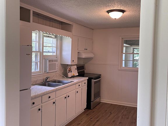 Spacious kitchen with brand new fridge.