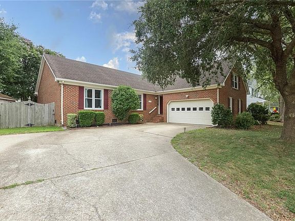 The driveway has space for multiple cars.