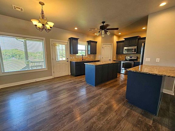 Open floor plan with kitchen and dining area open to the living room