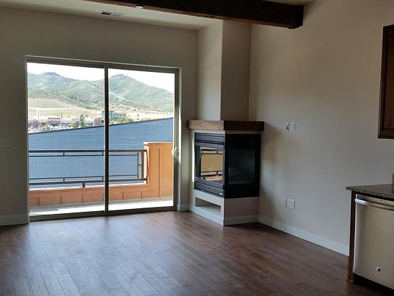 Living Room with balcony looking at mountains.