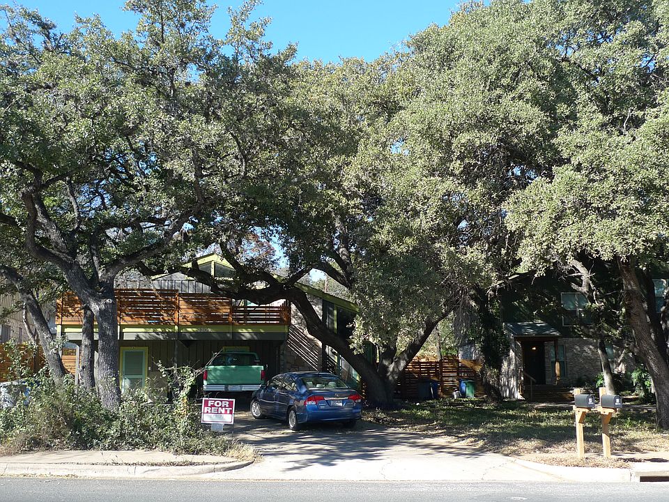 The duplex is on a tree-lined street. Unit B is on the right side of the building.