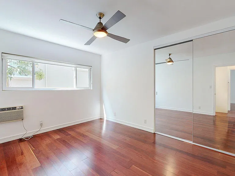 BEDROOM HAS LARGE DOUBLE MIRRORED CLOSET W/ CUSTOM SHELVING