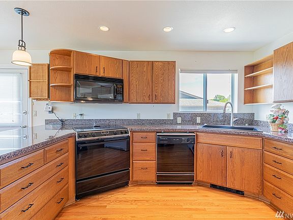 What a delightful kitchen. Lots of counter space, light and bright too. Check out the storage. 