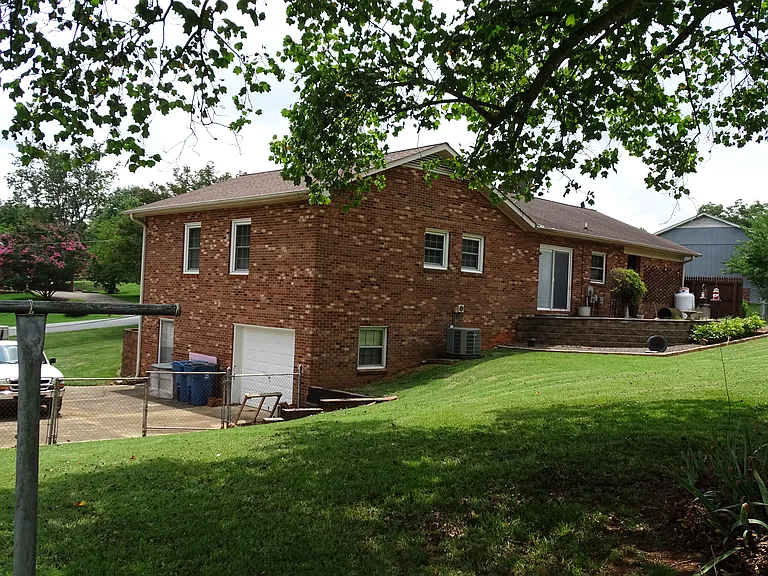 Back of home with bricked back patio.