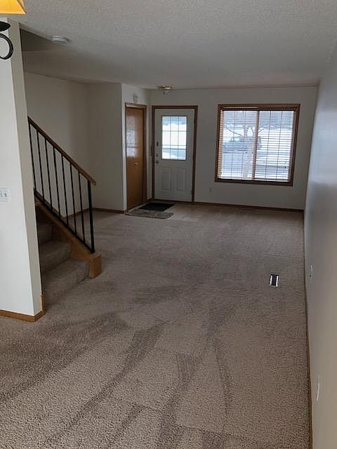 Large living room with coat closet at the front entrance.