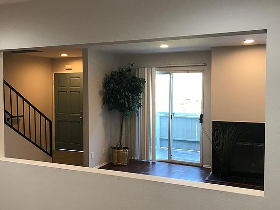 View into living room and staircase to second living space from formal dining room.