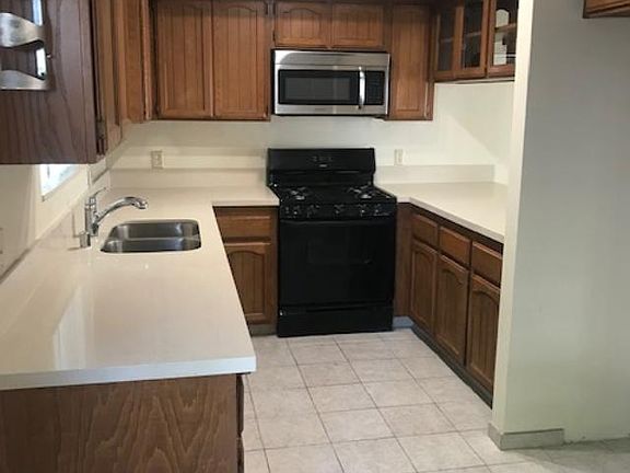 Kitchen - new countertop, new stainless steel sink, new lighting. Dishwasher, trash compactor, microwave, oven.