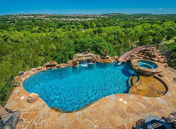 Resort style pool with a slide, wading area and fountain.  Room to entertain!