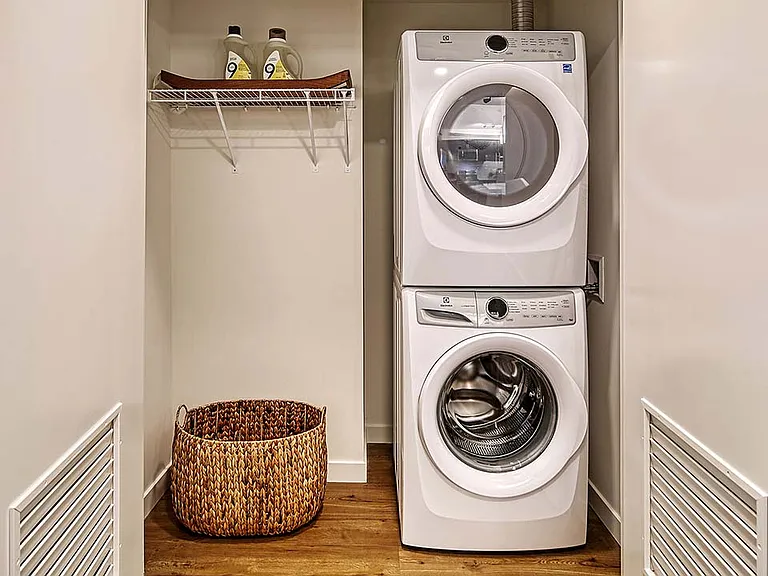 Griffis Shoreline apartment laundry closet with stacked washer dryer.