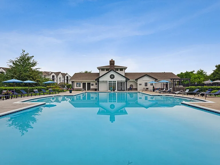 Relax by the sparkling pool at Eagle Rock Apartments at Belcamp. Surrounded by lush landscaping and modern amenities, this inviting space is perfect for unwinding or socializing. Explore your new lifestyle today!
