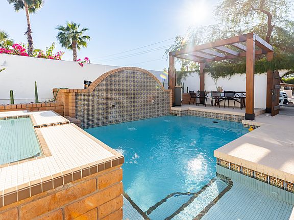 Hot tub, pool and outdoor dinning. Far right is front gate of the property.