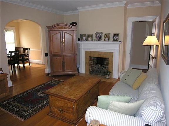 Living Room has stone masonry fireplace, hardwood floors, and beautiful archwa