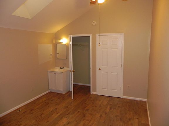 Second level bedroom with sink, closet, ceiling fan & skylight