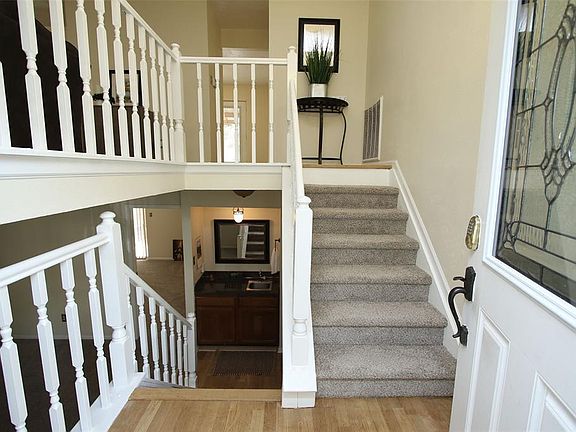 Color coordinated new carpet with the natural wood look entry floor.