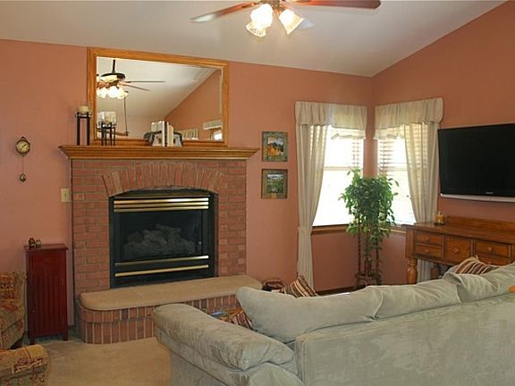 Living Room with Brick Fireplace with He