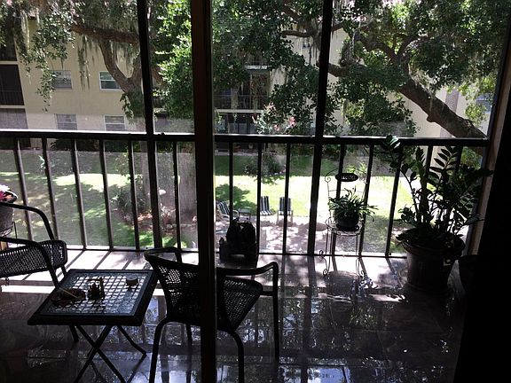 Screened porch overlooking garden and pool area