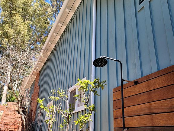 Outdoor shower next to garage entrance