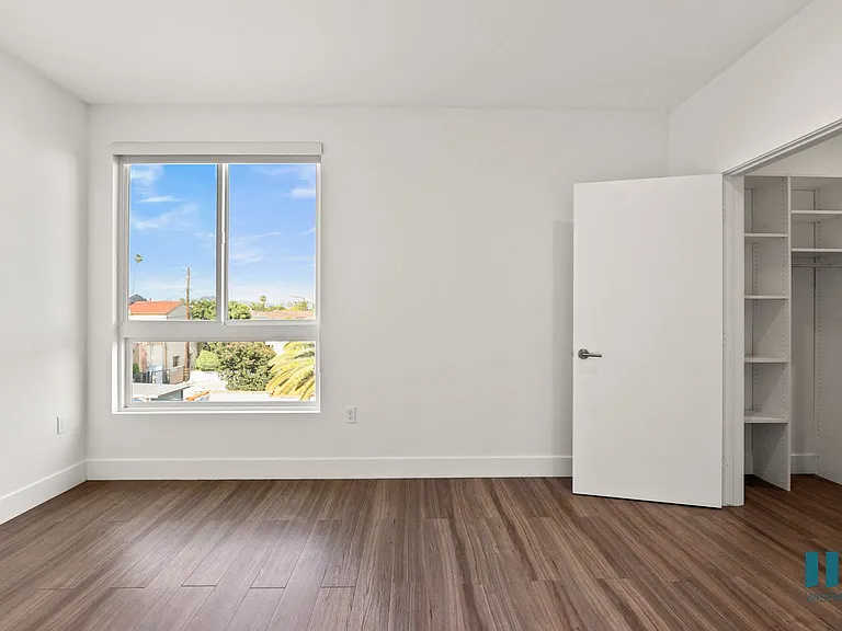 Bedroom with Walk-In Closet with Built-In Organizers and Large-Size Windows
