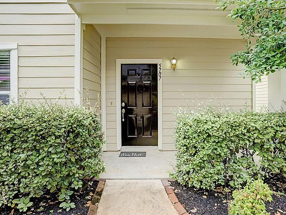 Guests are greeted by this charming covered front porch surrounded by mature landscaping. Let's take a closer look inside. I promise, you will not be disappointed.