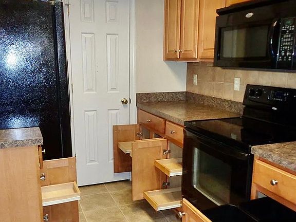 Kitchen has pull out drawers for easy access.