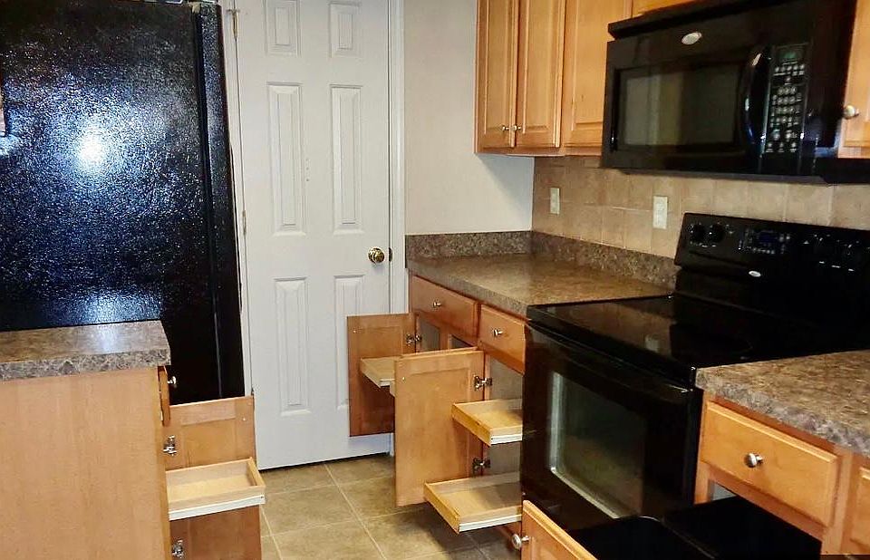 Kitchen has pull out drawers for easy access.