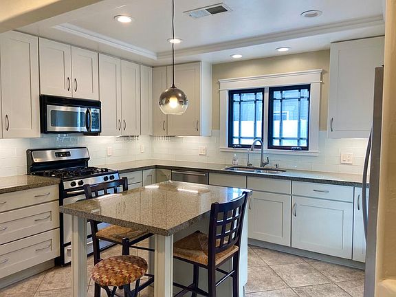 Loads of counter space with glass tiled backsplash