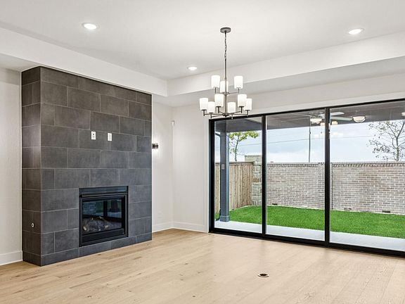 The great room features a multi-slide door and cozy fireplace