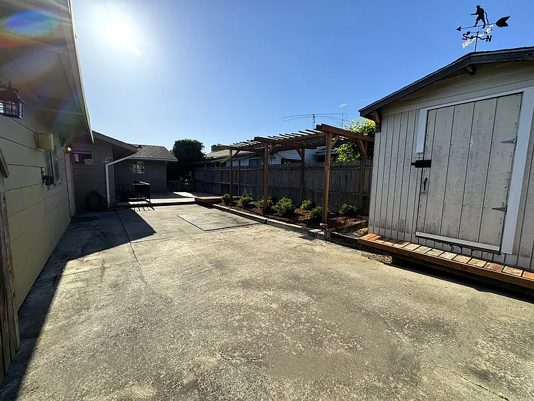 Back patio of house with parking