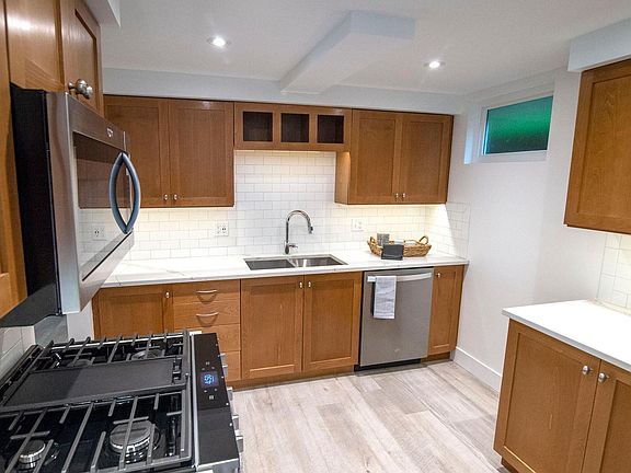 This kitchen has new quartz countertops & new stainless appliances to include a large gas range.