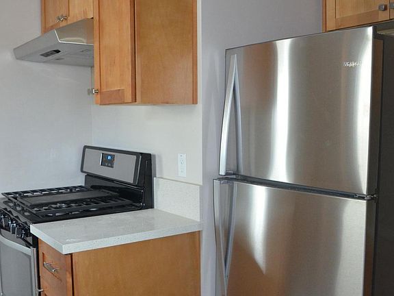 Kitchen with stainless appliances: gas stove, refrigerator,