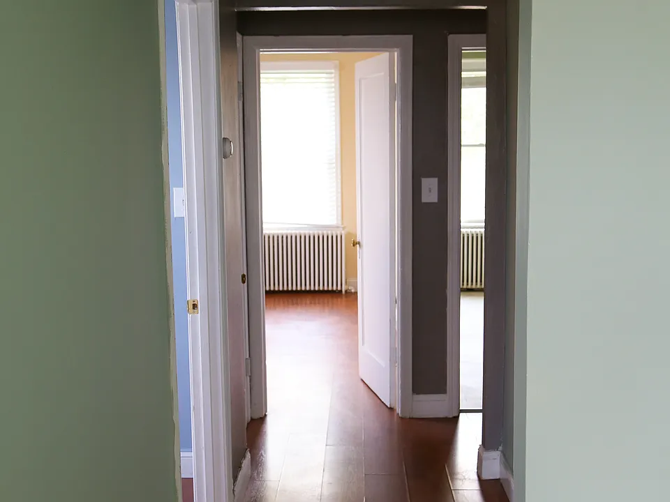 Hallway with Den on left, Bedroom straight ahead, and Kitchen to the right
