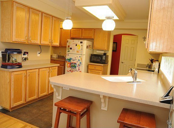 Spacious kitchen with corion countertops, tile floors and ample counter space