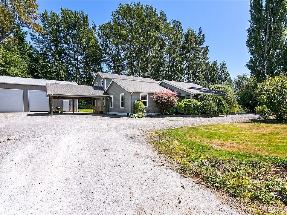 Front of home with double carport and detached shop/garage