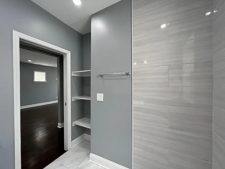 Newly renovated bathroom with linen closet. Note: glass shower door will be installed before tenant moves in.