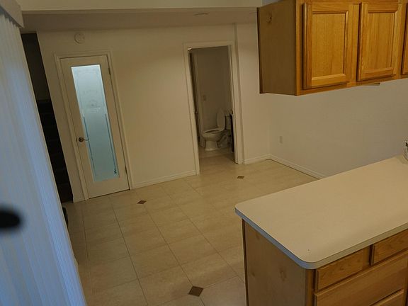 Dinning room (Pantry door on the left & downstairs bathroom on the right background)