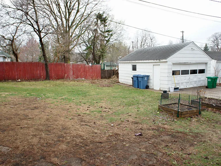 Raised garden beds and private driveway leading to a 2 car garage that can be available.