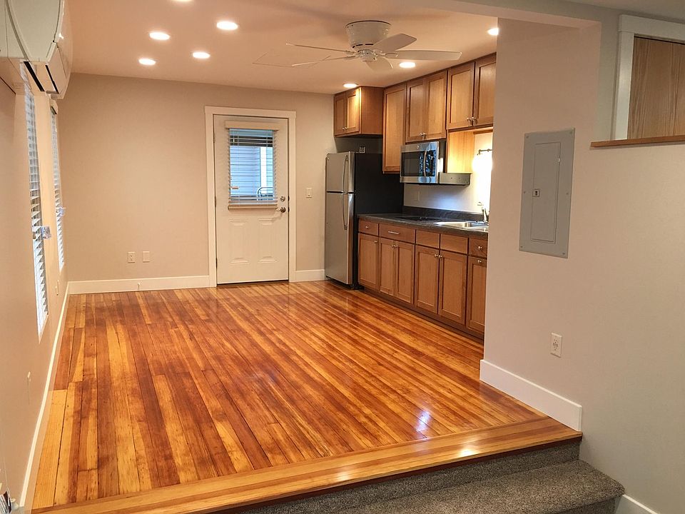 Living room and kitchen area with refinished original hardwo