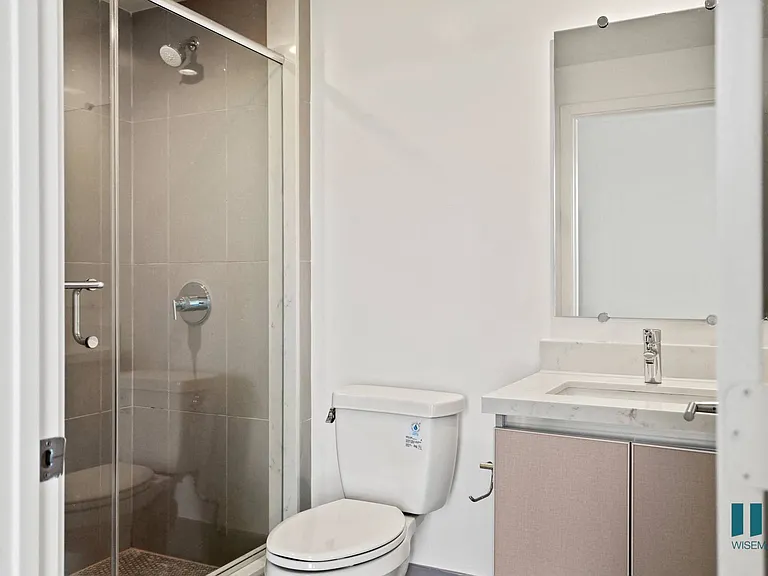 Bathroom with Stand-In Shower with Glass Door and Vanity Cabinet Storage