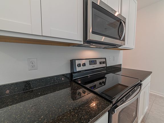 Modern white cabinets and granite countertops in our Bold Package.