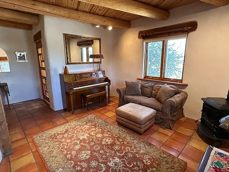 Downstairs den with woodturning stove Yama piano in excellent condition